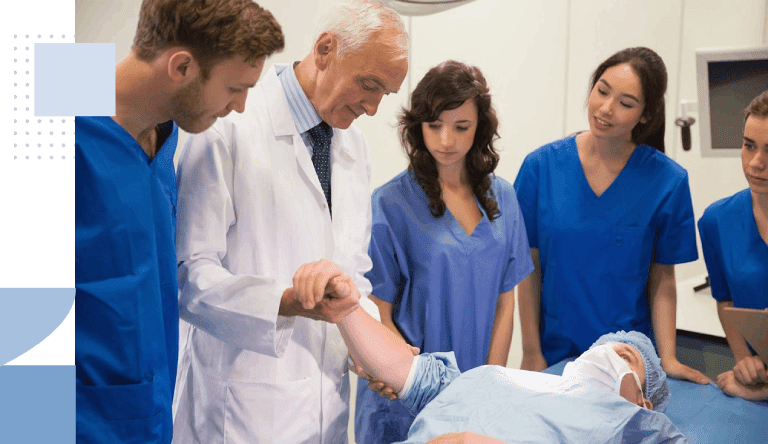 Medical students and professor checking pulse Health Care Learning Center